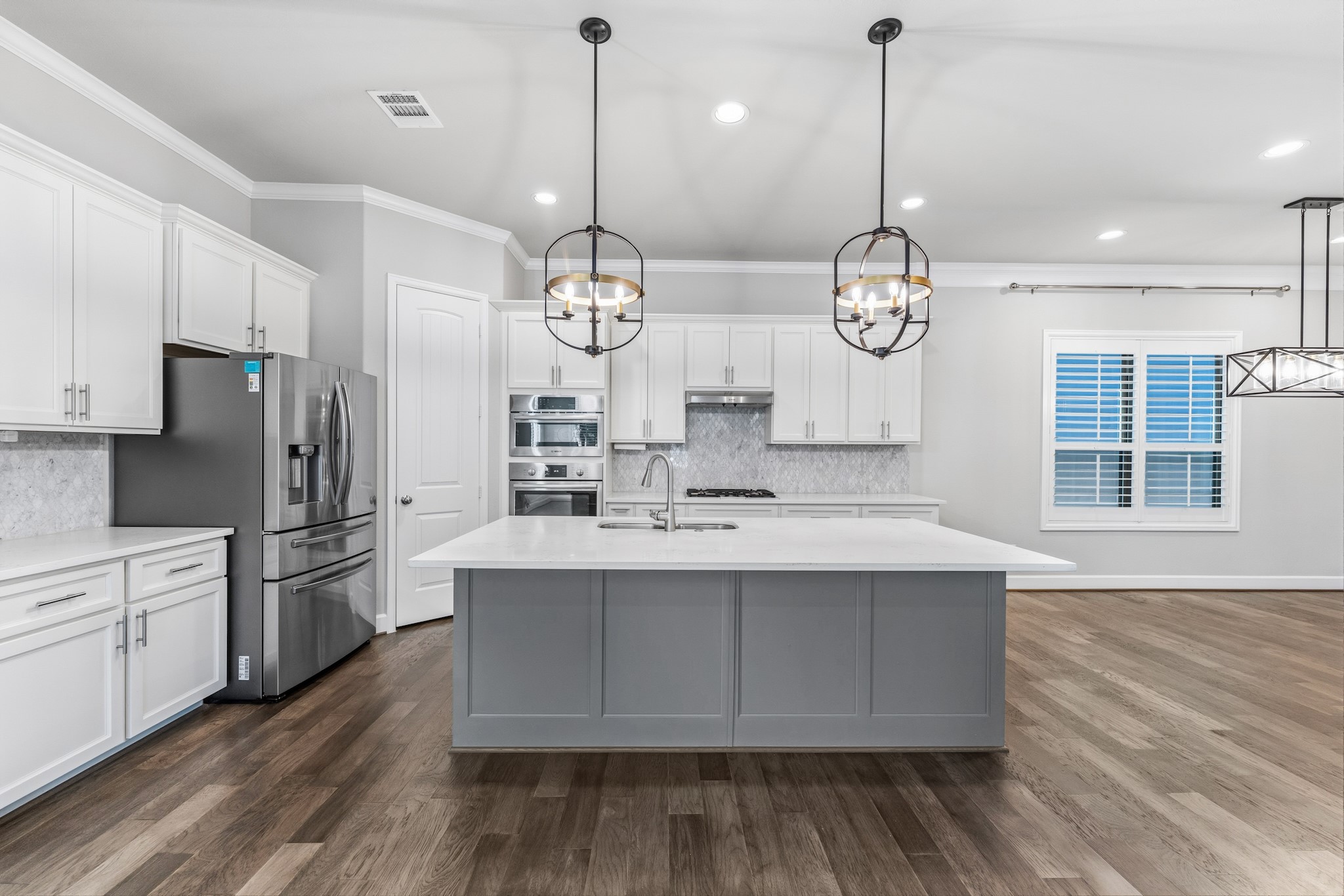 2607 Nicholson Street Houston, TX 77008 - Photo 7 of 29 a large kitchen with stainless steel appliances a large center island attached withe living room