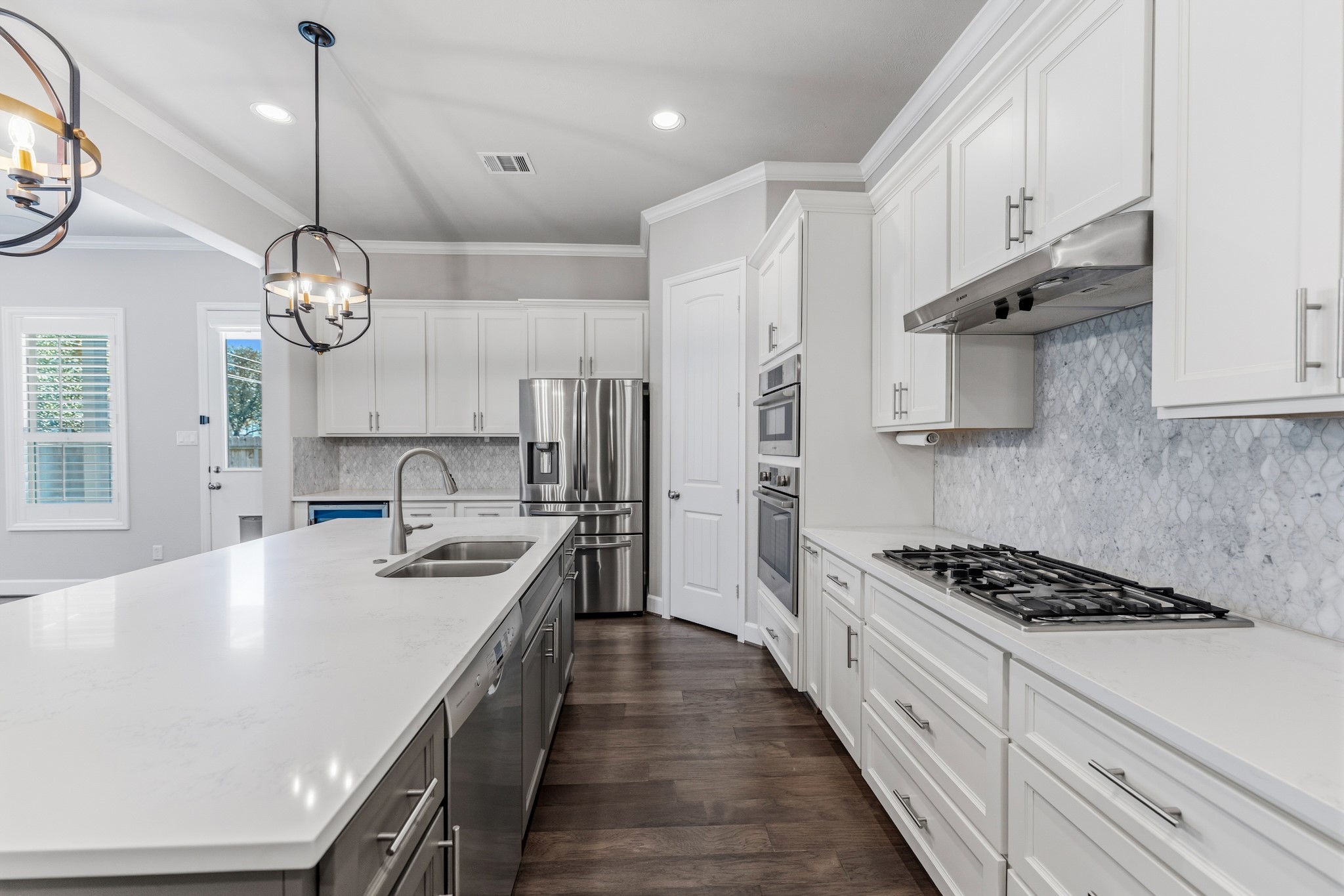 2607 Nicholson Street Houston, TX 77008 - Photo 8 of 29 a kitchen with stainless steel appliances a stove a sink dishwasher and white cabinets with wooden floor