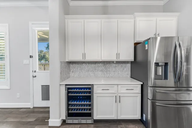 a kitchen with stainless steel appliances white cabinets and a refrigerator