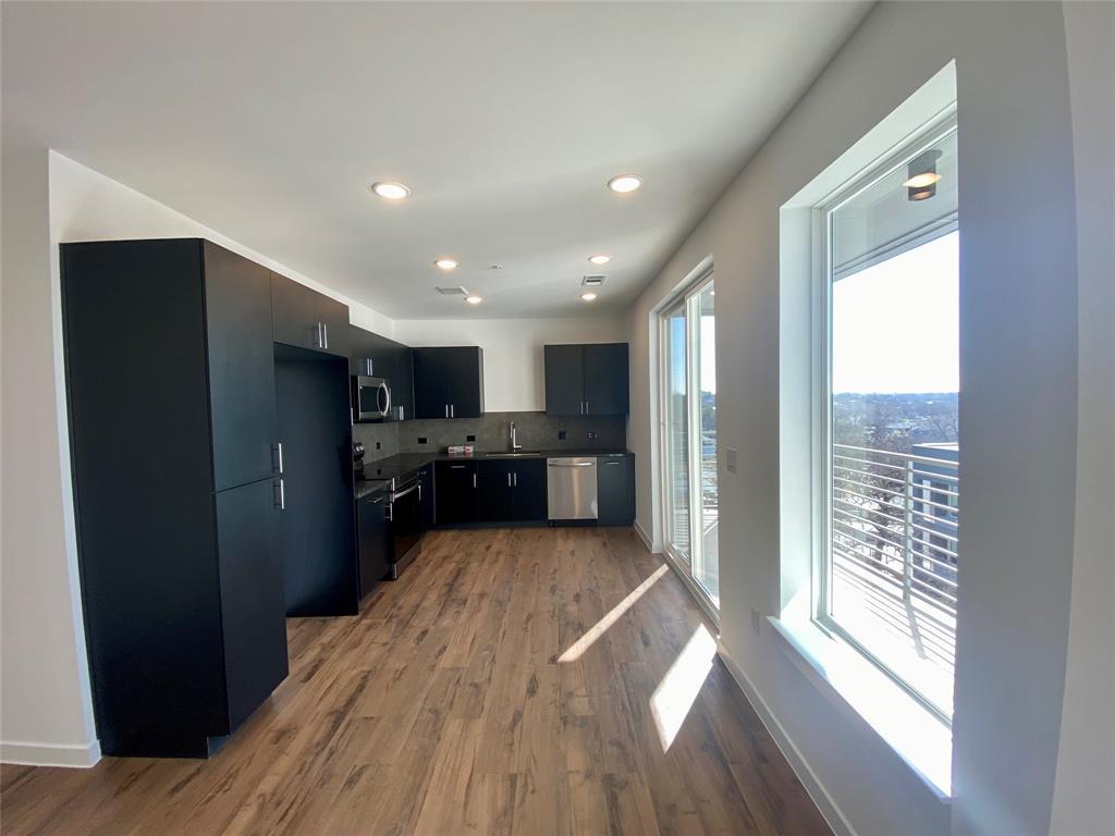 4801 Springdale Road, Unit 2408 Austin, TX 78723 - Photo 2 of 22 a view of kitchen with refrigerator and wooden floor