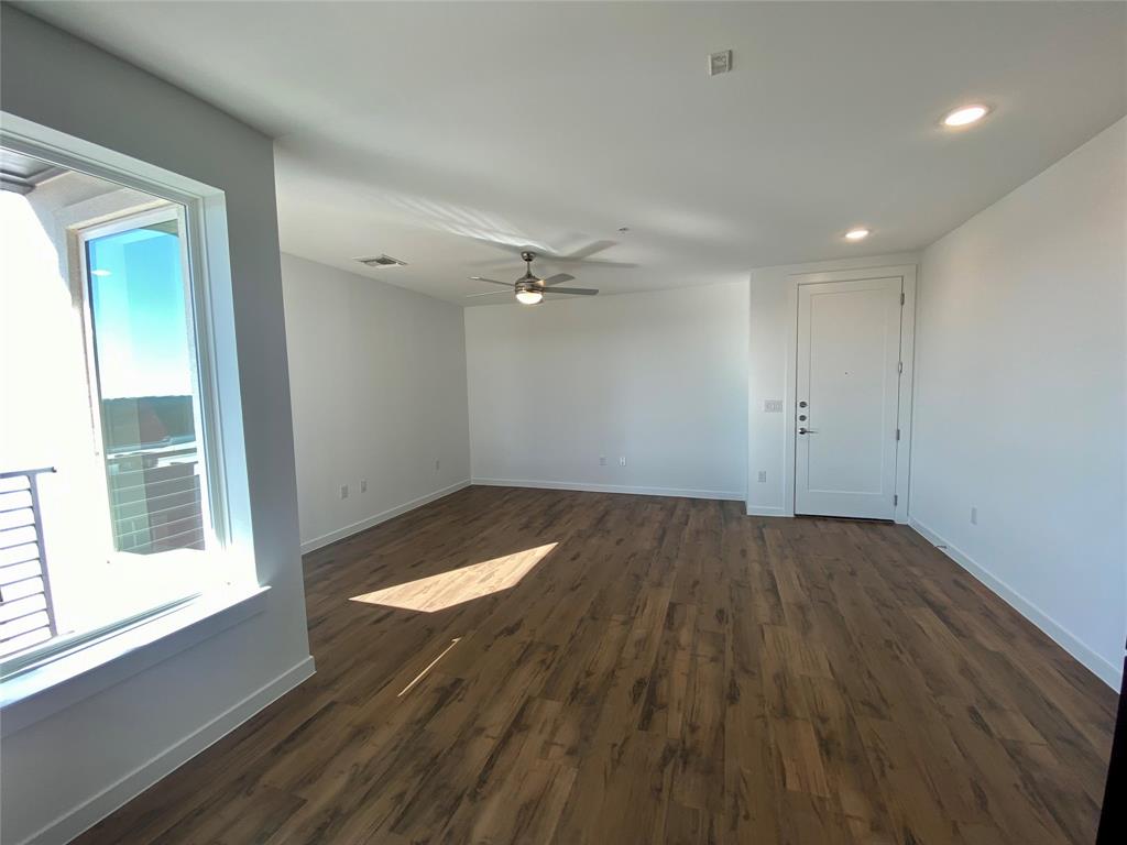 4801 Springdale Road, Unit 2408 Austin, TX 78723 - Photo 4 of 22 wooden floor in an empty room with a window