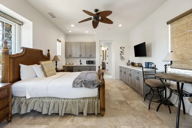 a spacious bathroom with a large tub sink and mirror