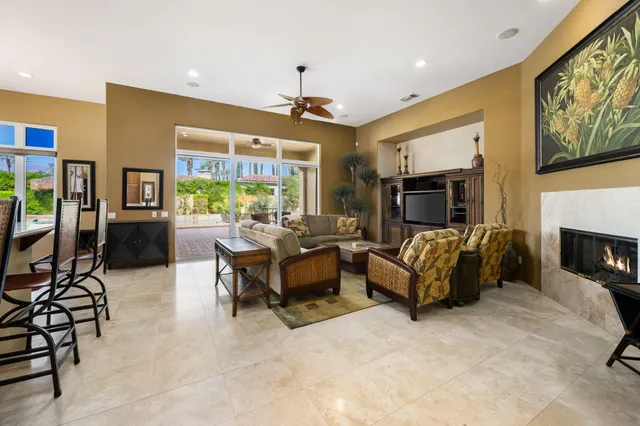 a kitchen with stainless steel appliances kitchen island granite countertop a refrigerator and microwave