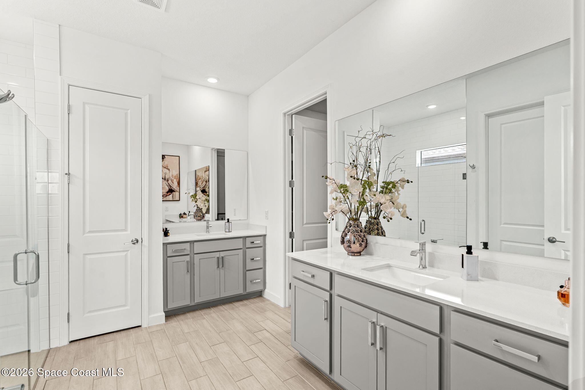 8904 Alister Drive Melbourne, FL 32940 - Photo 27 of 91 a bathroom with a sink double vanity and a mirror