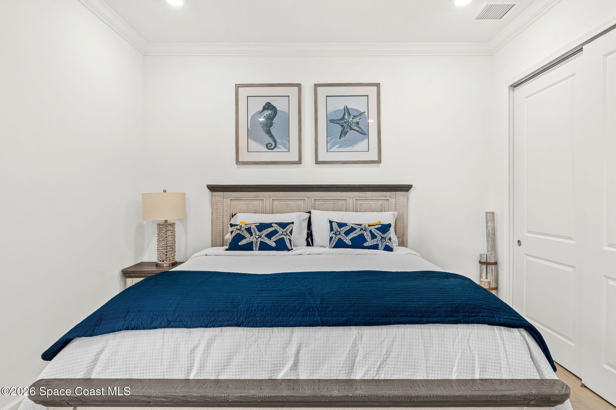 8904 Alister Drive Melbourne, FL 32940 - Photo 41 of 91 a bedroom with a bed and painting on the wall