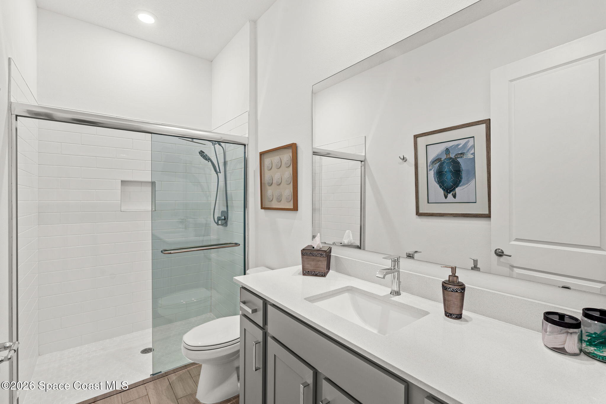 8904 Alister Drive Melbourne, FL 32940 - Photo 43 of 91 a bathroom with a double vanity sink toilet and shower