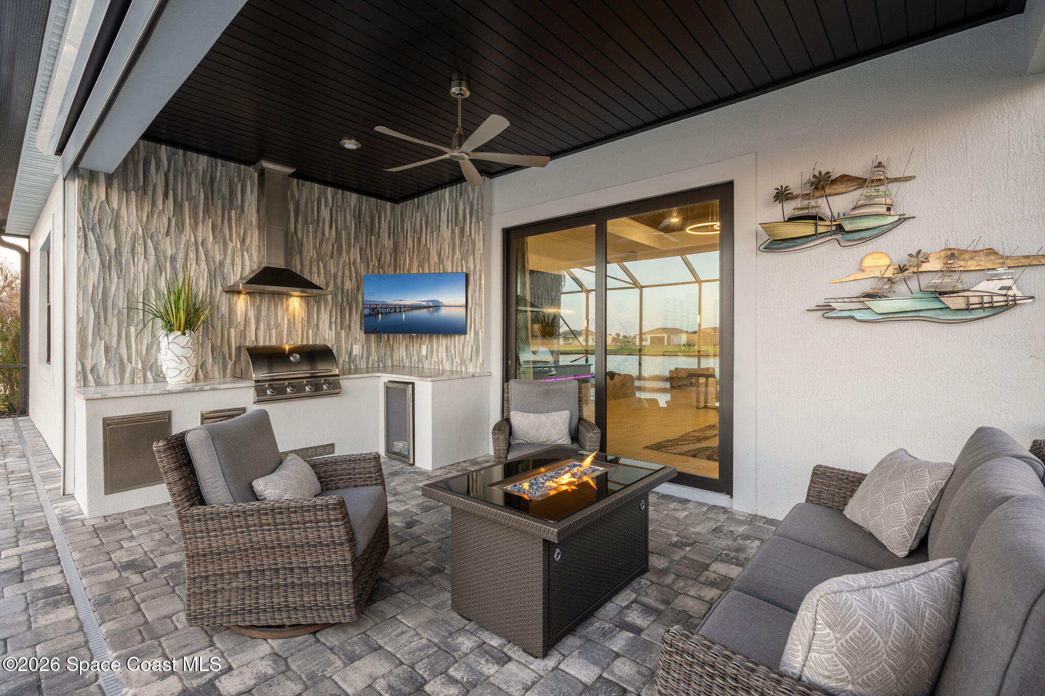 8904 Alister Drive Melbourne, FL 32940 - Photo 50 of 91 a living room with furniture and a flat screen tv