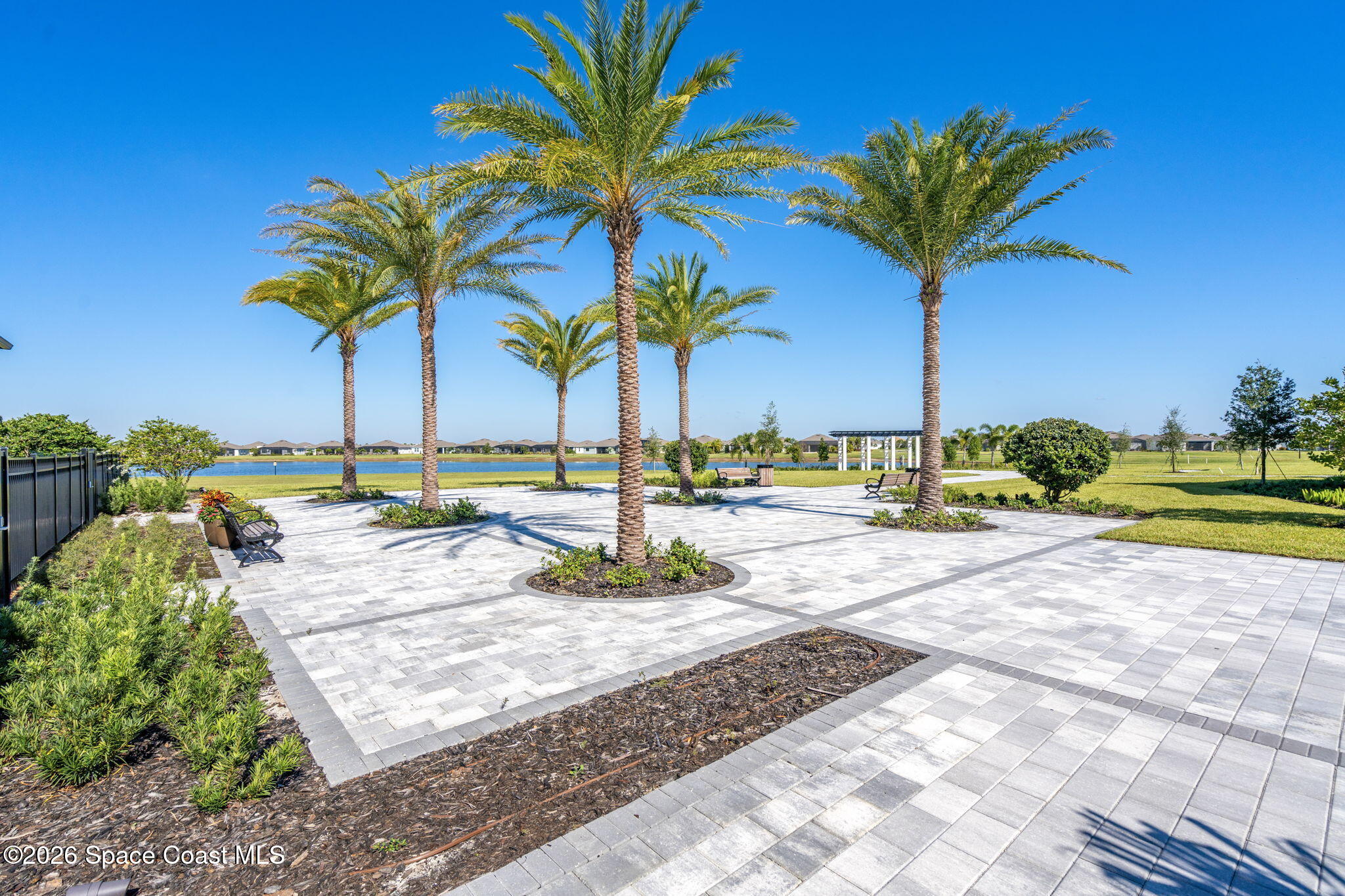 8904 Alister Drive Melbourne, FL 32940 - Photo 69 of 91 a view of a swimming pool with a table and chairs
