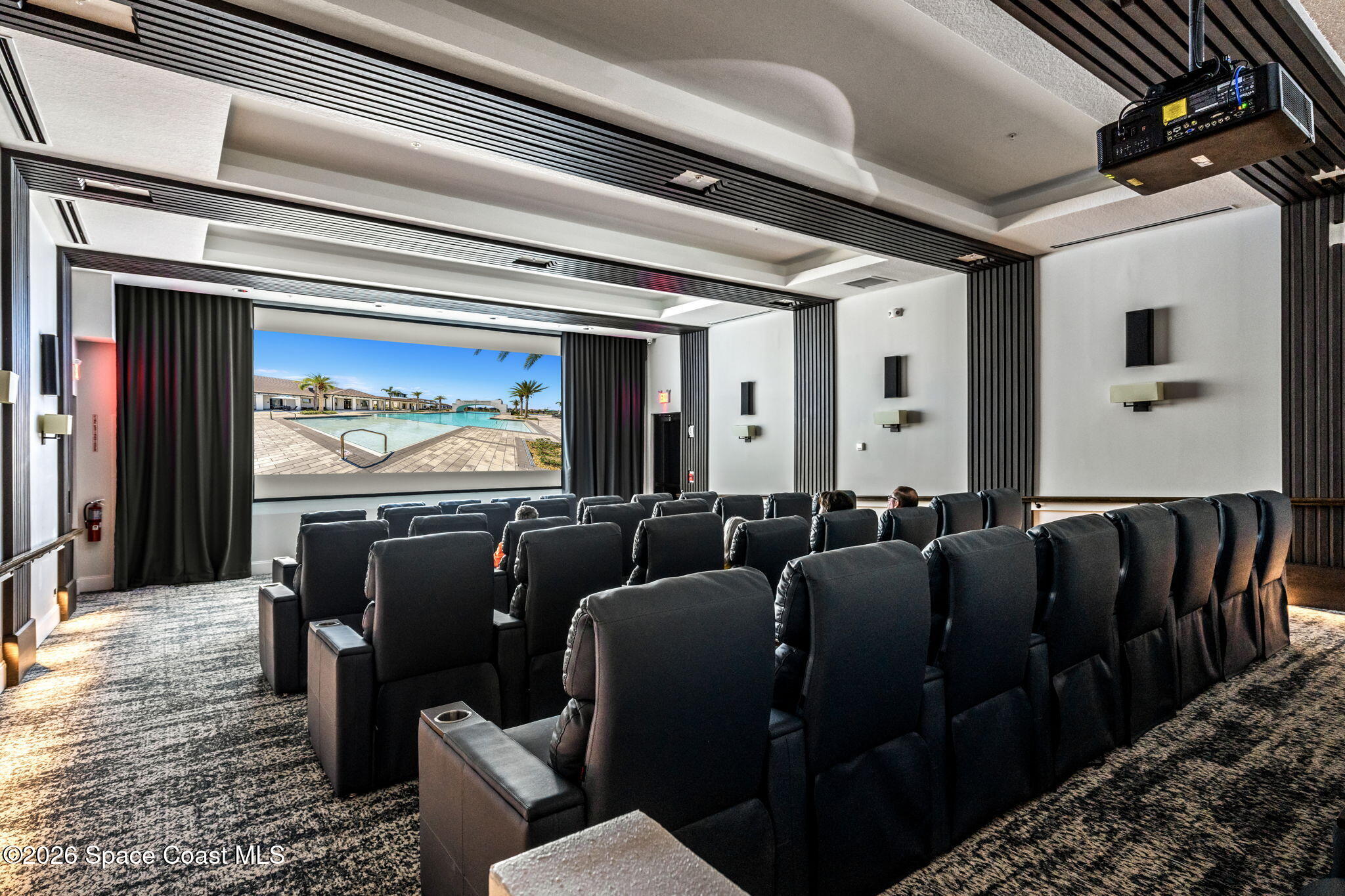 8904 Alister Drive Melbourne, FL 32940 - Photo 81 of 91 a media room with lots of chairs and a projector
