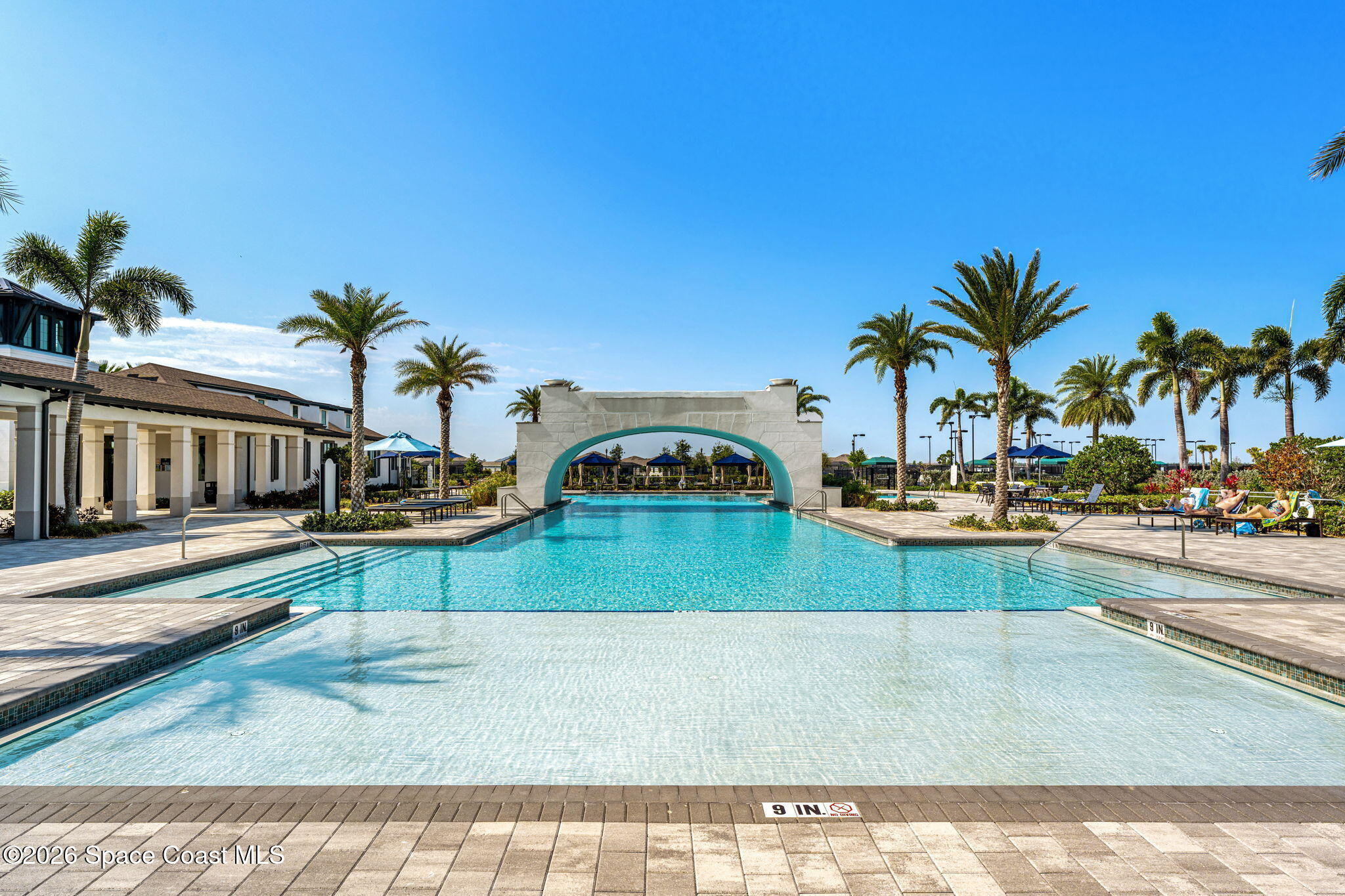 8904 Alister Drive Melbourne, FL 32940 - Photo 89 of 91 a view of a swimming pool and a longer chairs