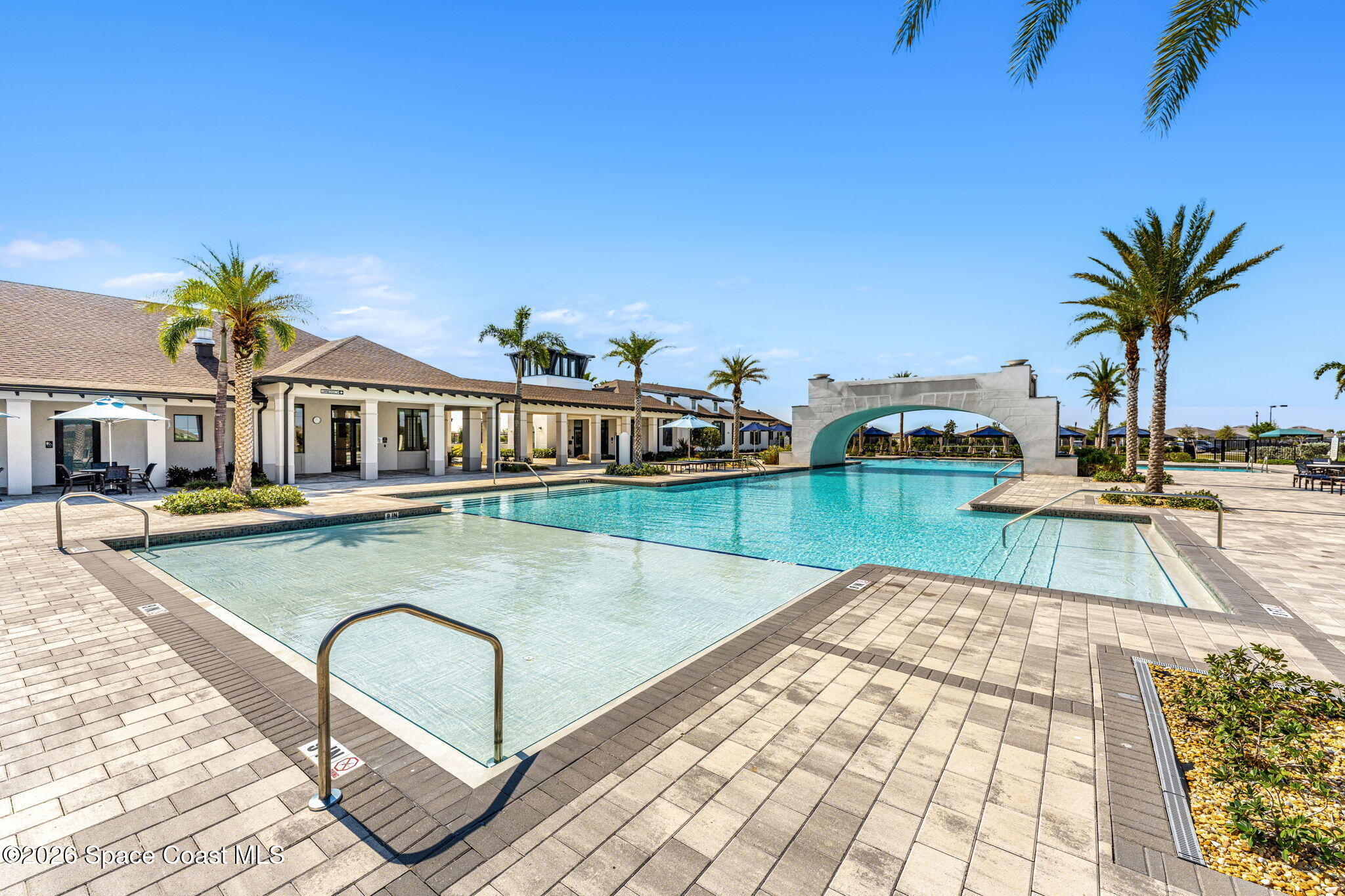 8904 Alister Drive Melbourne, FL 32940 - Photo 91 of 91 a view of swimming pool with outdoor seating and house in the background
