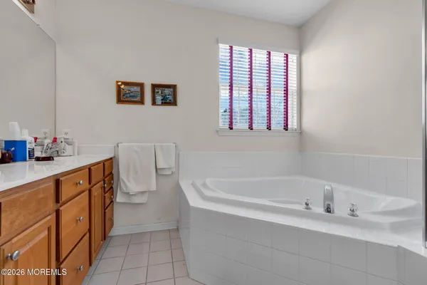 a bathroom with a bathtub sink and mirror