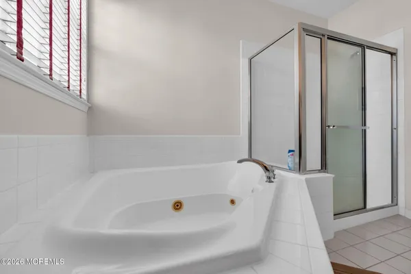 a bathroom with a tub and shower