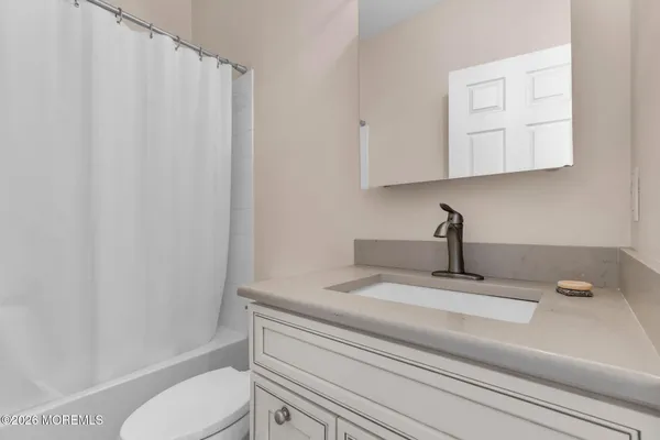 a bathroom with a sink a toilet and vanity