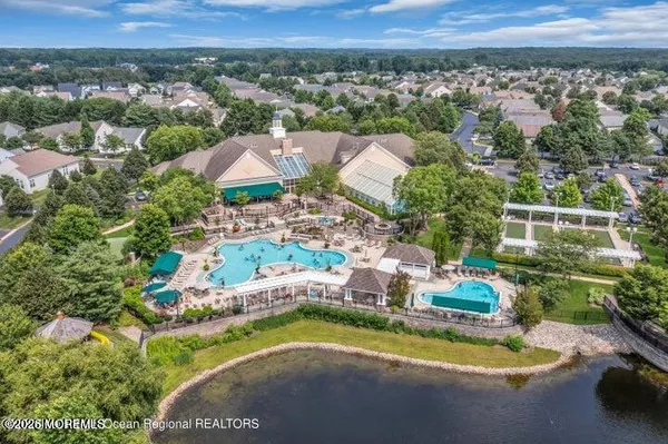 an outdoor space with lots of chairs and a chandelier