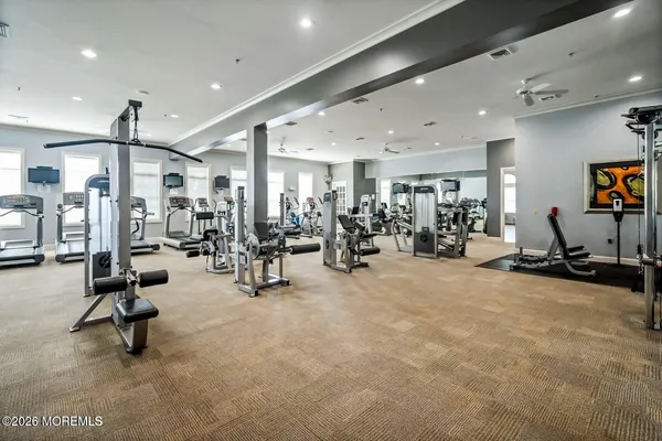 a room with pool table and windows