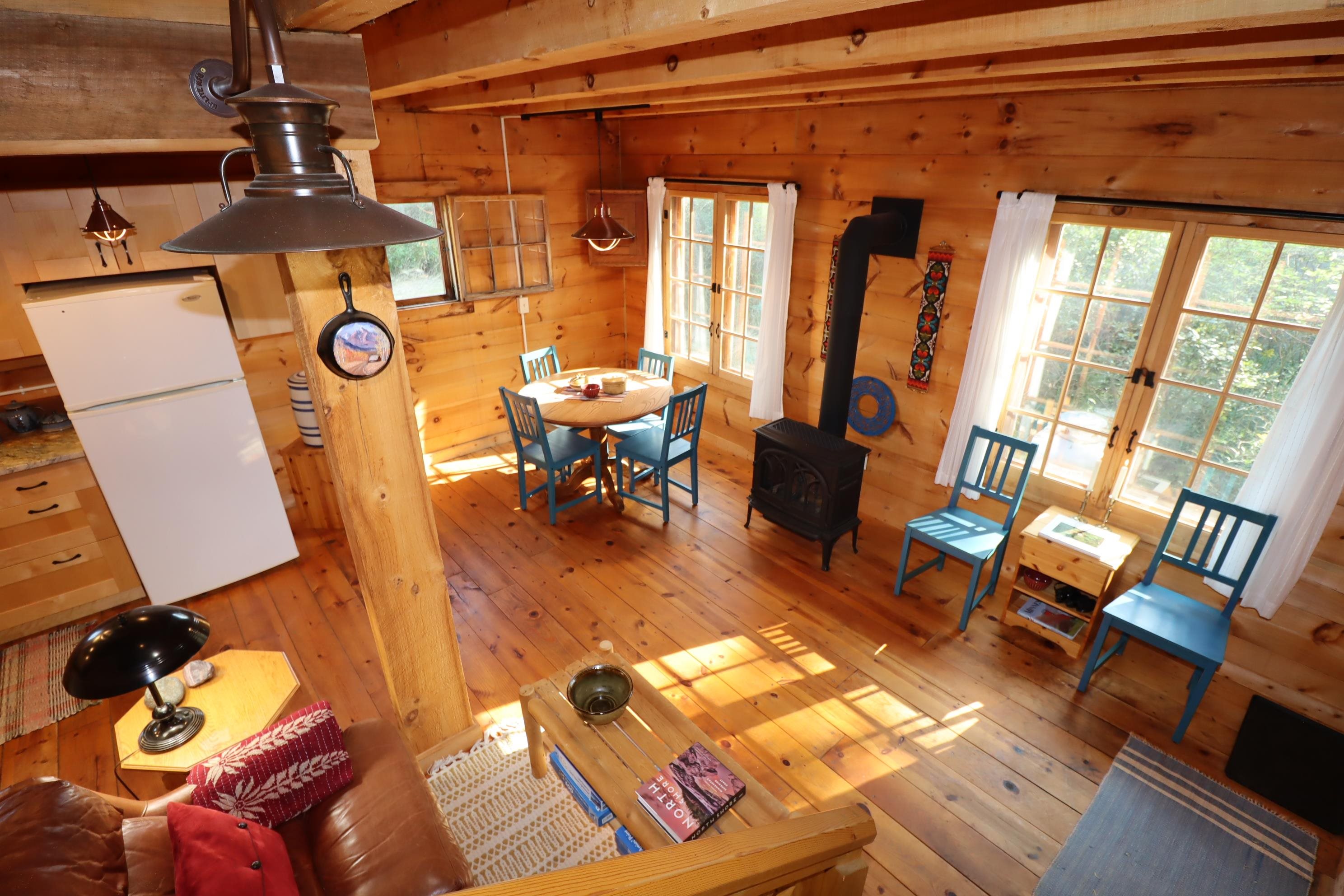 89595 Bark Point Road Herbster, WI 54844 - Photo 12 of 43 Living room featuring beam ceiling, hardwood/floors, wooden walls, and stove