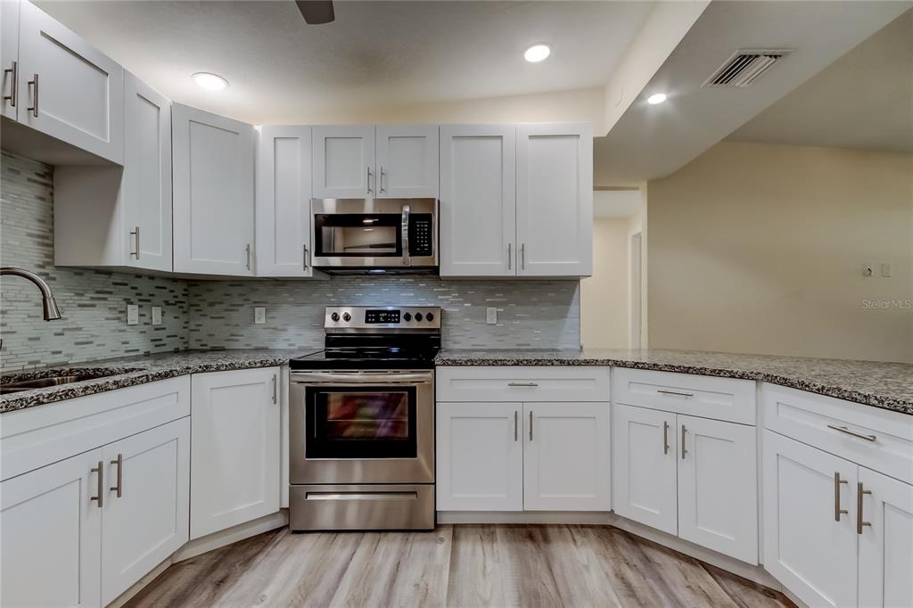 1353 Mary L Road Clearwater, FL 33755 - Photo 13 of 44 a kitchen with sink cabinets and stainless steel appliances