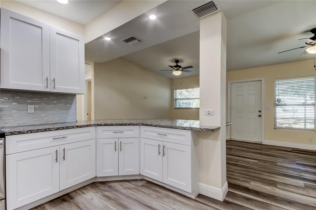 1353 Mary L Road Clearwater, FL 33755 - Photo 14 of 44 a kitchen with granite countertop white cabinets and a sink