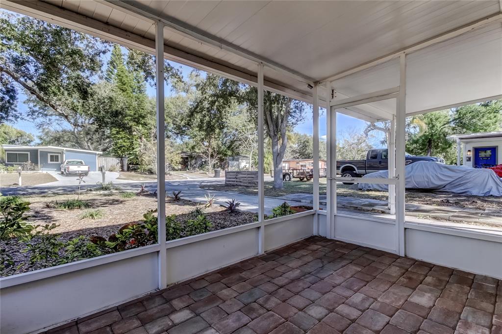 1353 Mary L Road Clearwater, FL 33755 - Photo 2 of 44 a kitchen with stainless steel appliances kitchen island wooden cabinets and table