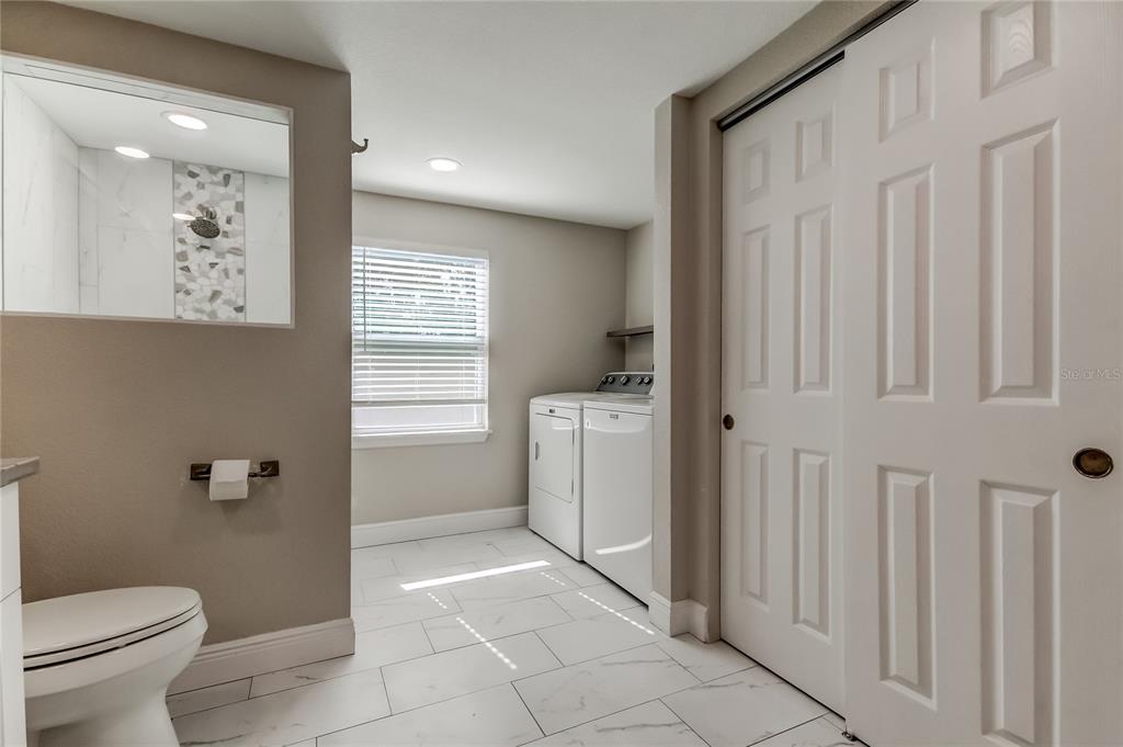 1353 Mary L Road Clearwater, FL 33755 - Photo 24 of 44 a bathroom with a toilet sink and tub