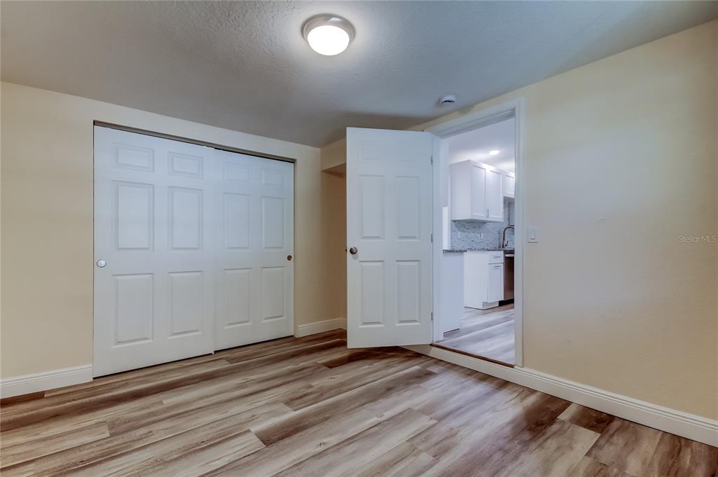 1353 Mary L Road Clearwater, FL 33755 - Photo 28 of 44 wooden floor in an empty room