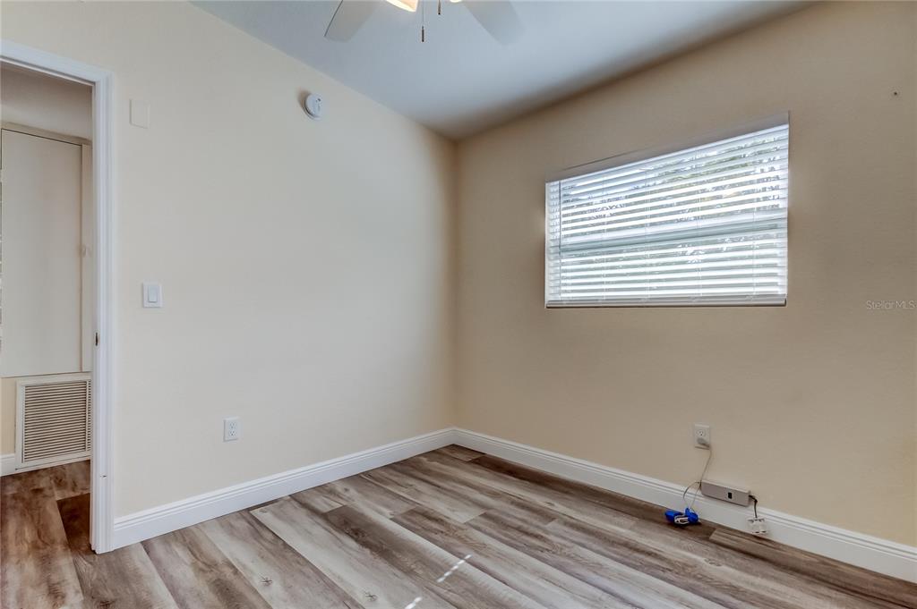 1353 Mary L Road Clearwater, FL 33755 - Photo 34 of 44 a room with a wooden floor and a window