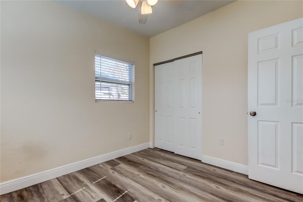 1353 Mary L Road Clearwater, FL 33755 - Photo 36 of 44 a view of an empty room with wooden floor and a window