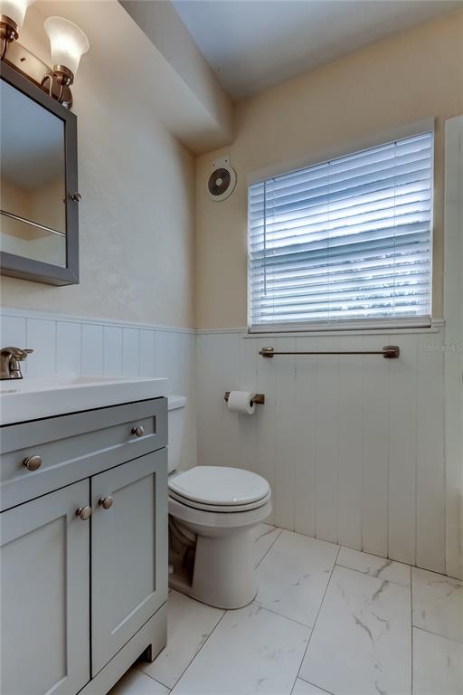 1353 Mary L Road Clearwater, FL 33755 - Photo 38 of 44 a bathroom with a toilet sink and mirror
