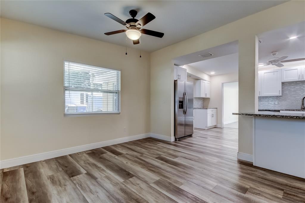 1353 Mary L Road Clearwater, FL 33755 - Photo 5 of 44 a view of an empty room with wooden floor and a window