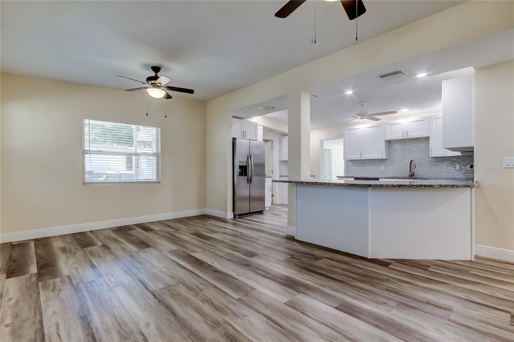 1353 Mary L Road Clearwater, FL 33755 - Photo 7 of 44 a view of an empty room with window and a ceiling fan