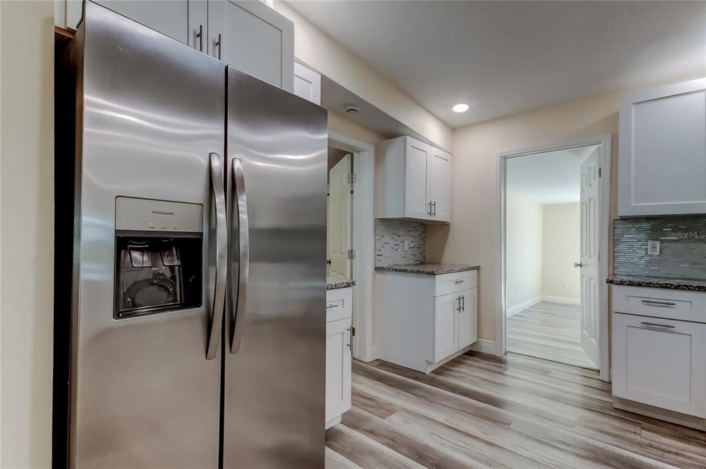 1353 Mary L Road Clearwater, FL 33755 - Photo 9 of 44 a kitchen with a refrigerator and a stove top oven