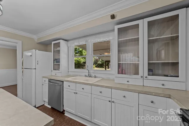 a kitchen with cabinets and window