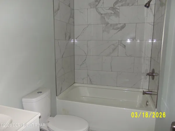 a bathroom with a bathtub and a toilet