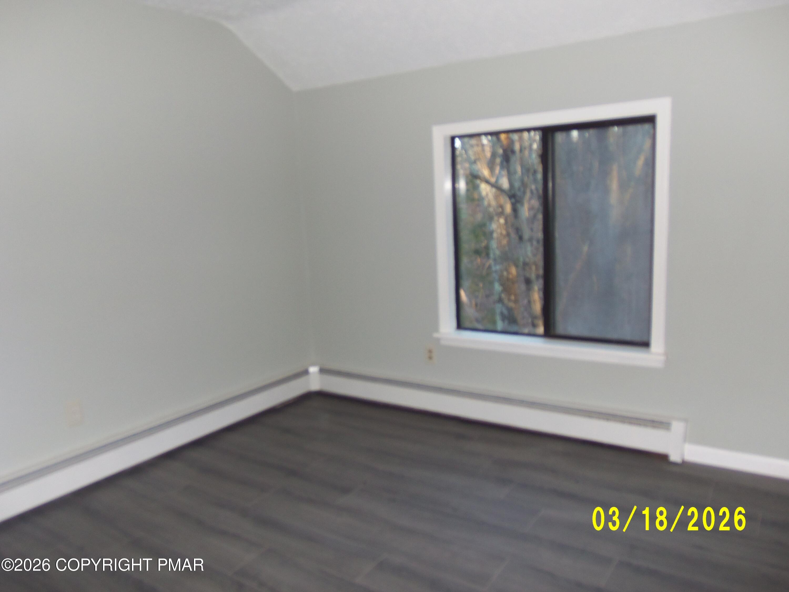 240 Powder Horn Road Henryville, PA 18332 - Photo 18 of 23 a view of an empty room with wooden floor and a window