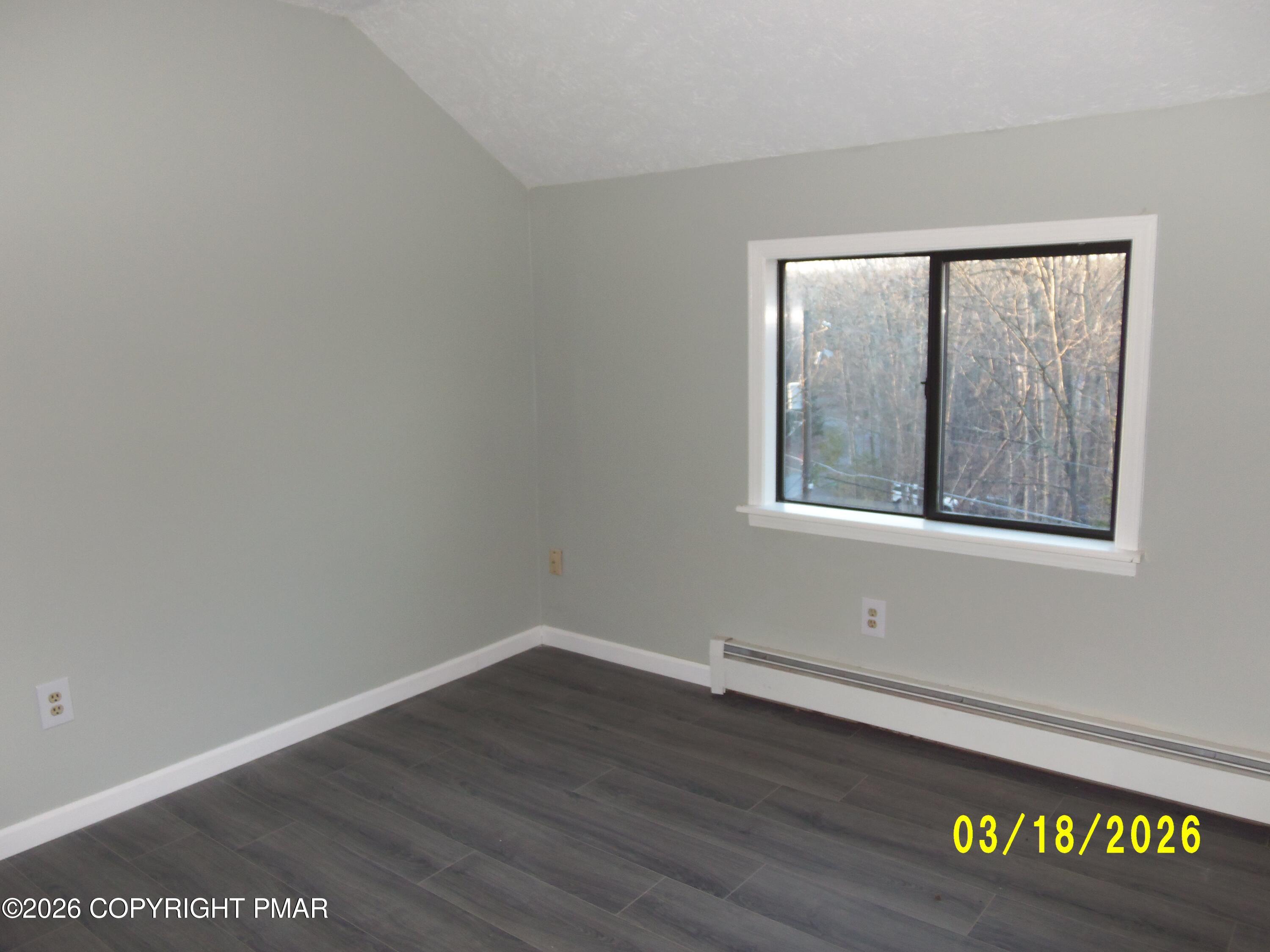240 Powder Horn Road Henryville, PA 18332 - Photo 20 of 23 a view of an empty room with wooden floor and a window
