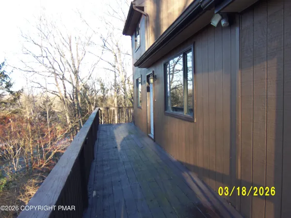 a view of a balcony with wooden floor