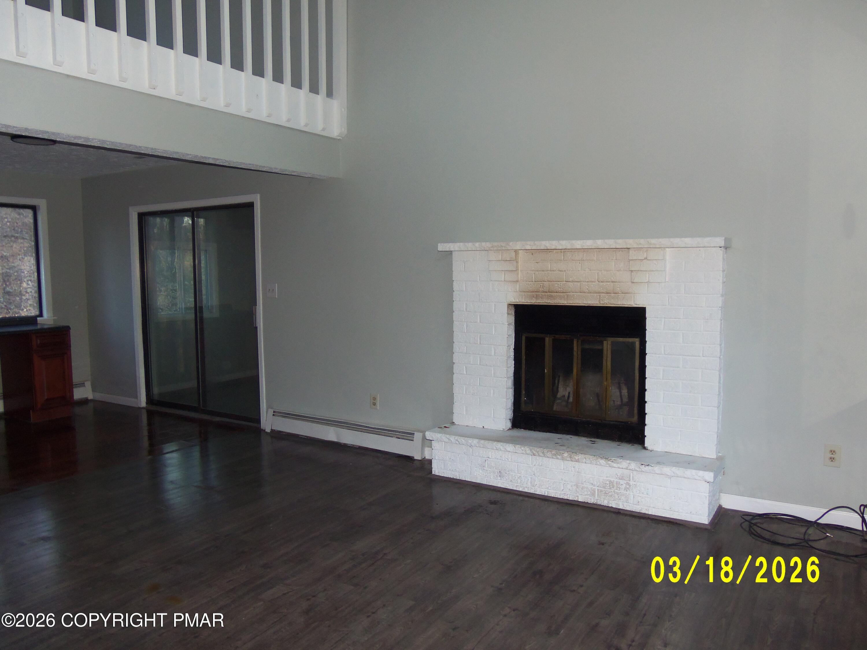 240 Powder Horn Road Henryville, PA 18332 - Photo 5 of 23 a view of an empty room with wooden floor and a fireplace