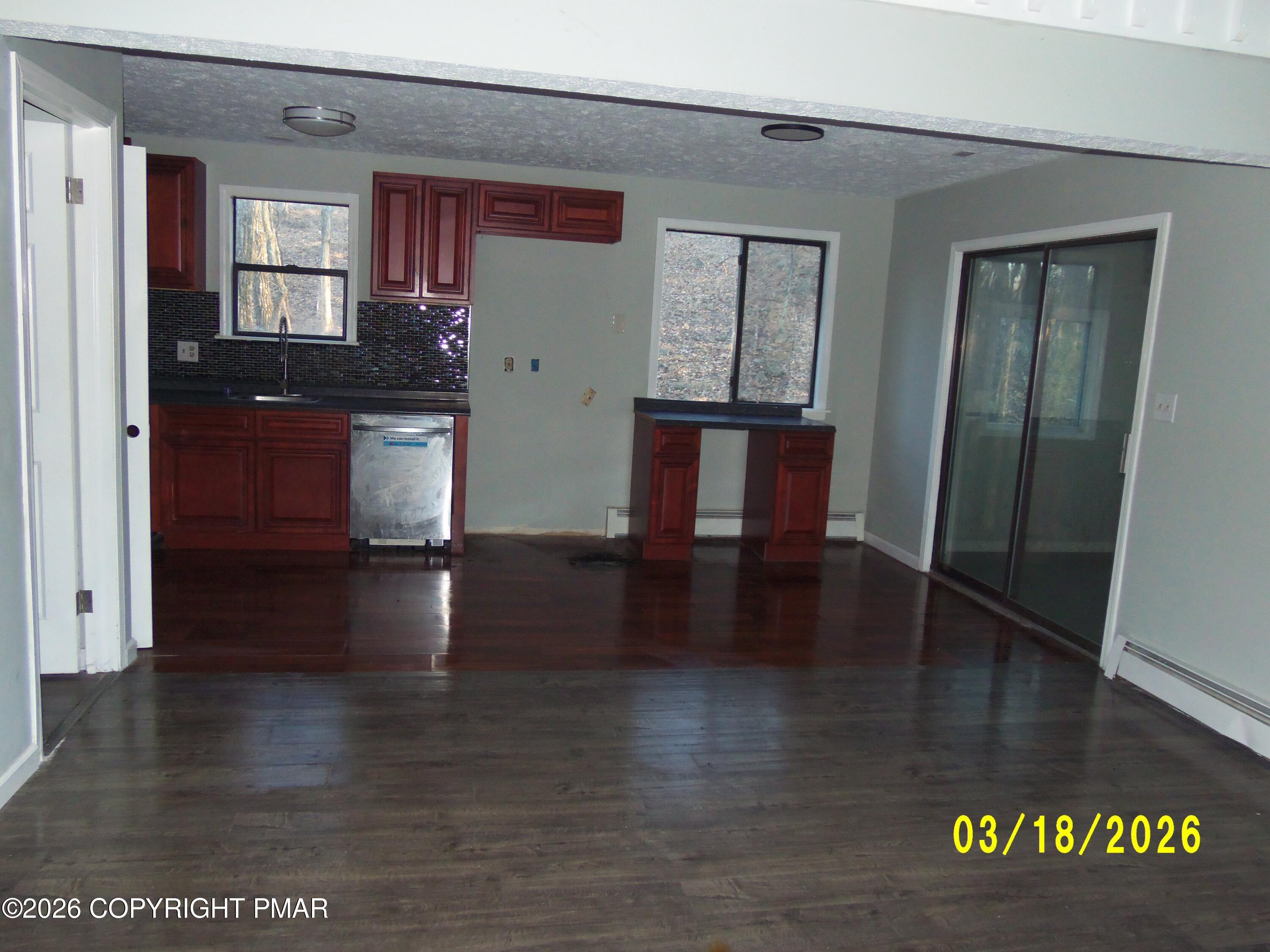 240 Powder Horn Road Henryville, PA 18332 - Photo 6 of 23 a view of a hallway with wooden floor and a living room