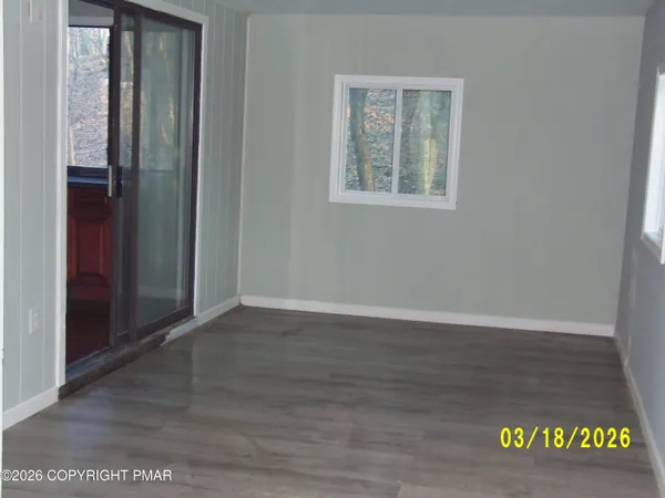 an empty room with wooden floor and closet