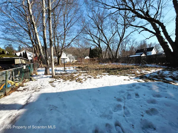 a view of a yard covered with snow