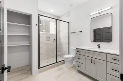 a bathroom with a toilet sink and mirror