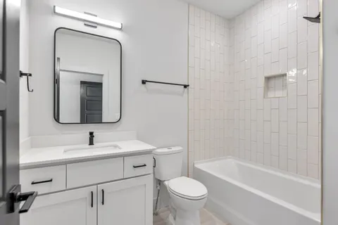 a bathroom with a toilet sink and bathtub
