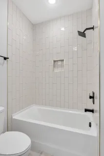 a bathroom with a bathtub and a toilet