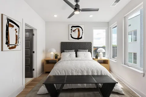 a bedroom with a large bed and a chandelier