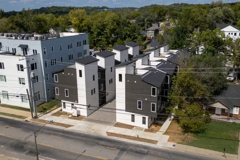 an aerial view of a house with a lake view