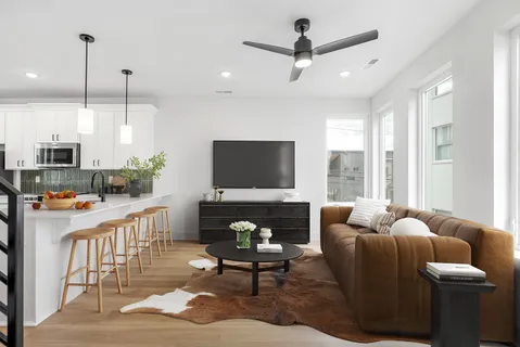 a living room with furniture a window and a flat screen tv