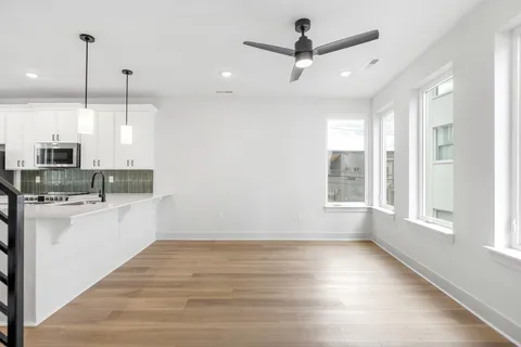 a view of a kitchen with a large window appliances and furniture