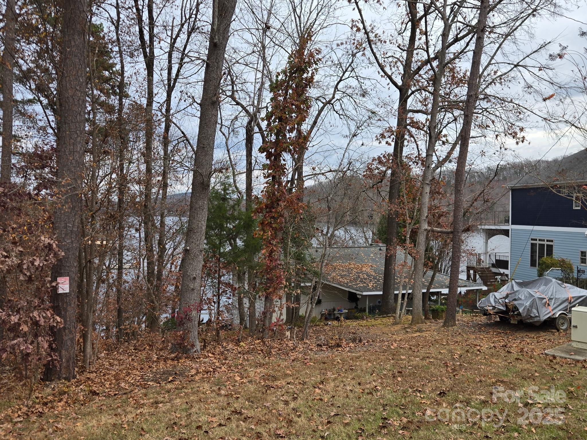 0 Shoreline Road, Unit 107 Badin Lake, NC 28127 - Photo 11 of 48 a view of a parked cars in front of a house