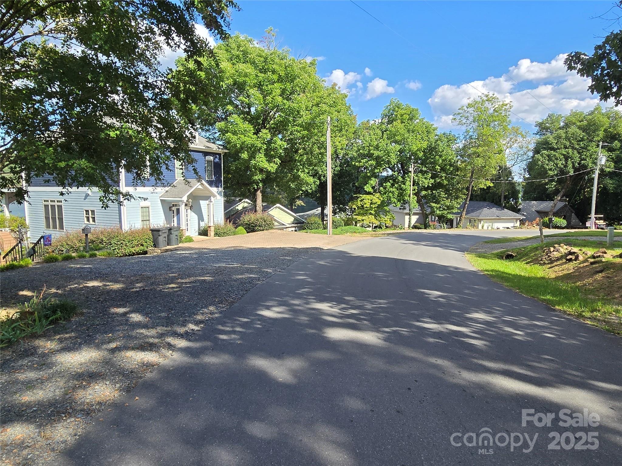0 Shoreline Road, Unit 107 Badin Lake, NC 28127 - Photo 21 of 48 a view of a street with a yard